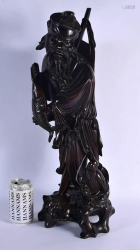 A LARGE 19TH CENTURY CHINESE CARVED ROOTWOOD FIGURE OF A FIS...