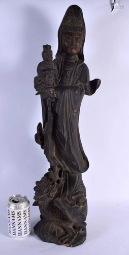 A LARGE 19TH CENTURY CHINESE CARVED WOOD FIGURE OF GUANYIN m...