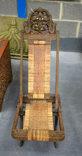 A 19TH CENTURY SOUTH EAST ASIAN CARVED WOOD FOLDING CHAIR. 1...