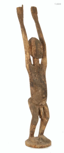Wooden ceremonial statue of a man with amulet
