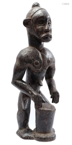 Wooden ceremonial statue of a man with drum
