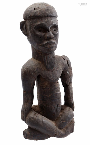 Wooden ceremonial statue of a seated person