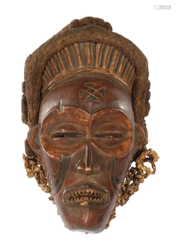 Wooden ceremonial mask decorated with flax and rope