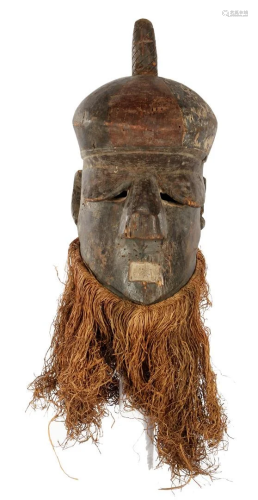 Wooden ceremonial mask decorated with flax