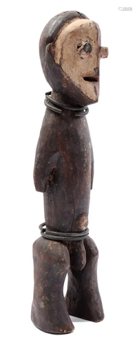 Cermonial wooden statue with metal rings