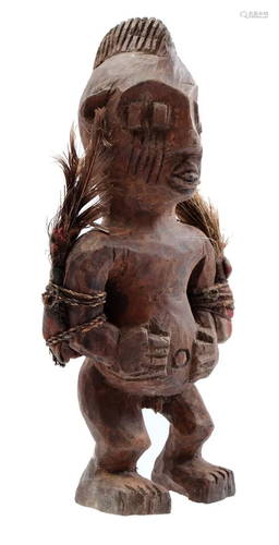 Wooden ceremonial statue with 4 eyes and feathers