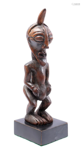 Wooden ceremonial statuette of a standing man