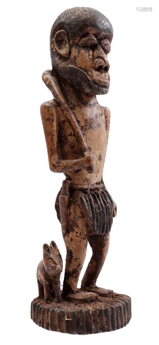 Wooden ceremonial statue of a man with a dog