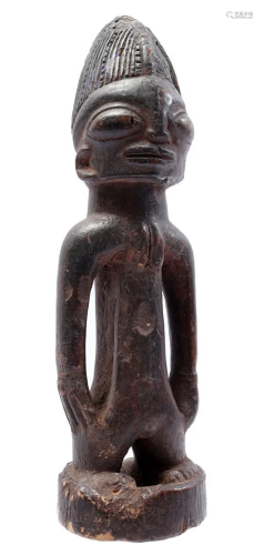 Wooden ceremonial statuette of a standing person