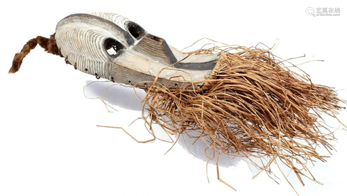 Wooden ceremonial mask decorated with grass