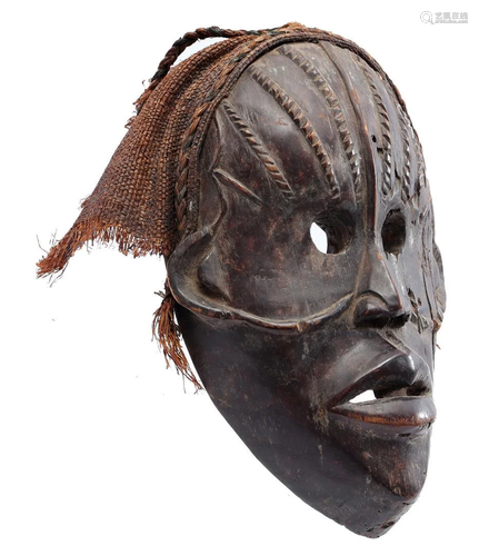 Wooden ceremonial mask decorated with flax