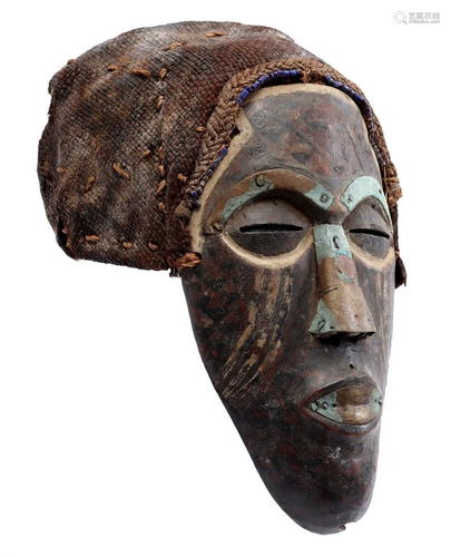 Wooden ceremonial mask with closed mouth