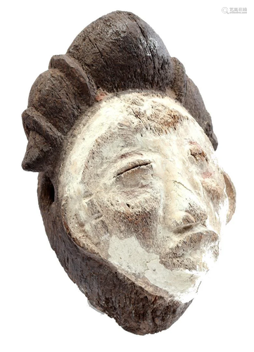 Wooden ceremonial mask with white decoration