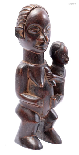 Wooden ceremonial figurine of a mother with child