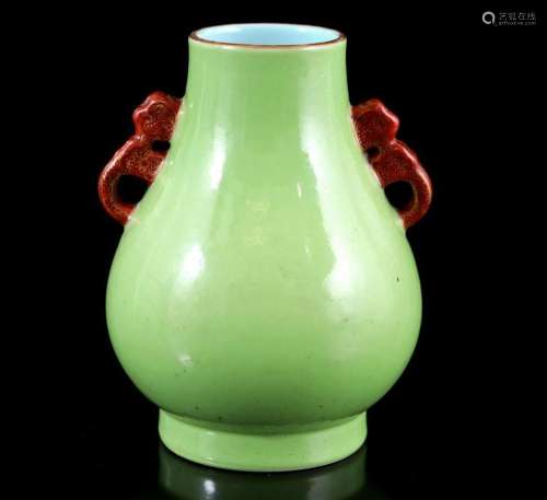 Porcelain vase with monochrome apple green décor