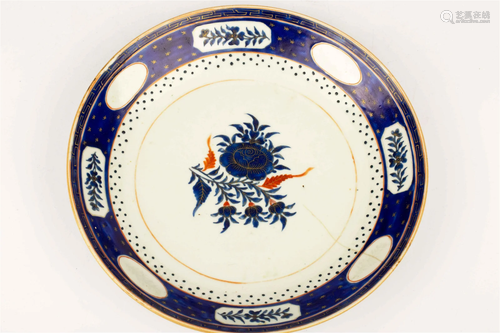 A BLUE GLAZED PLATE WITH FLORAL PATTERNS (WITH DAMAGE), EARL...