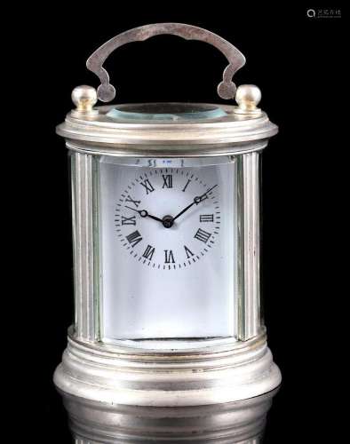 Round travel alarm clock in silver-coloured case