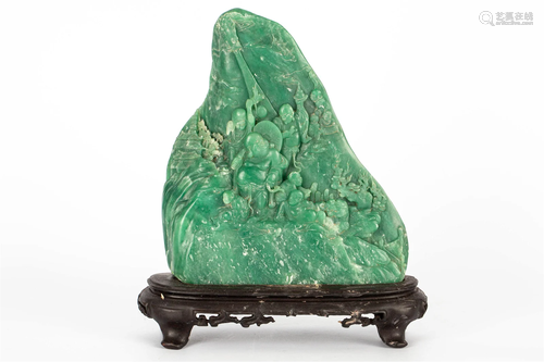 A GREEN STONE CARVED FIGURE ORNAMENT