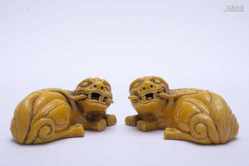 A pair of yellow glazed paperweight