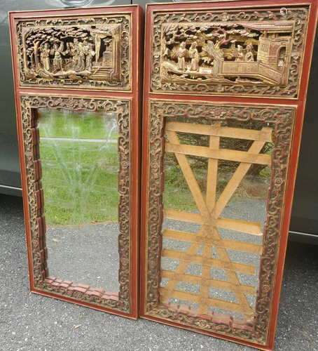 Pair of Chinese carved wood panel mirrors.