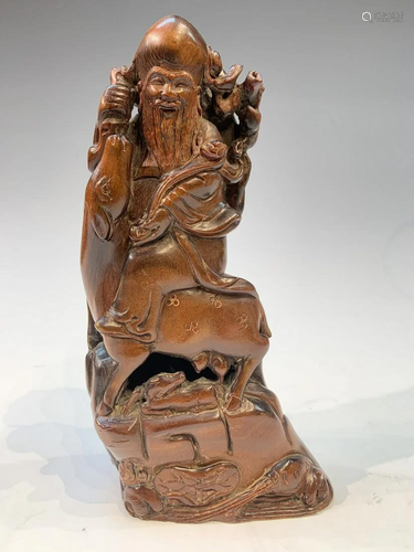 Horn carving of an old man riding a deer