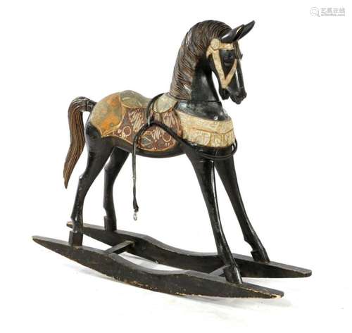 Wooden rocking horse with textile decoration