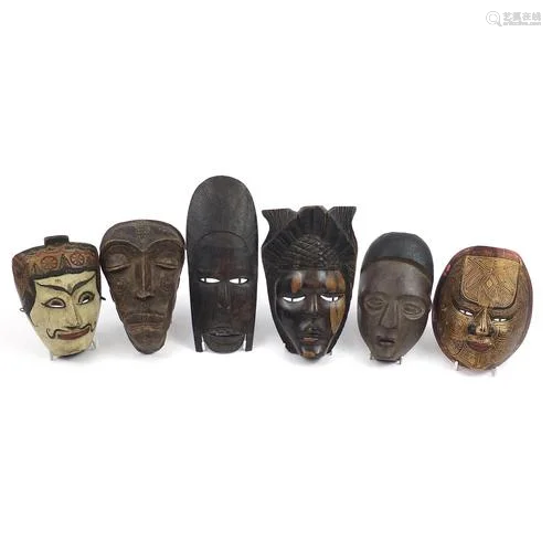 Six tribal interest carved wood face masks, the largest 31cm...