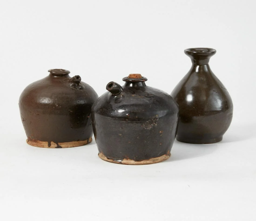 Three brown glazed pottery jugs