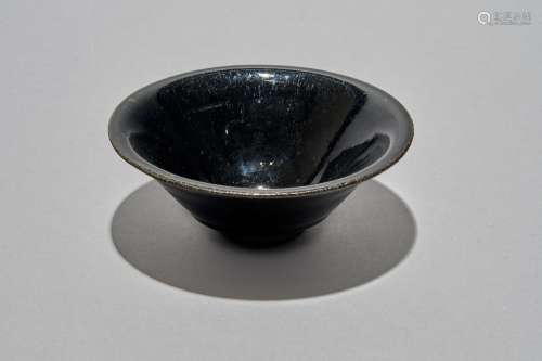 A black-glazed conical bowl