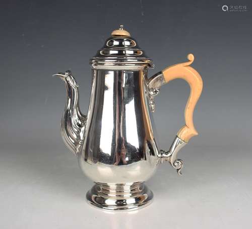 A George V silver baluster coffee pot with domed hinged lid,...