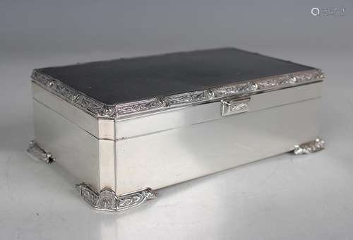 An Elizabeth II silver rectangular cigarette box, the engine...