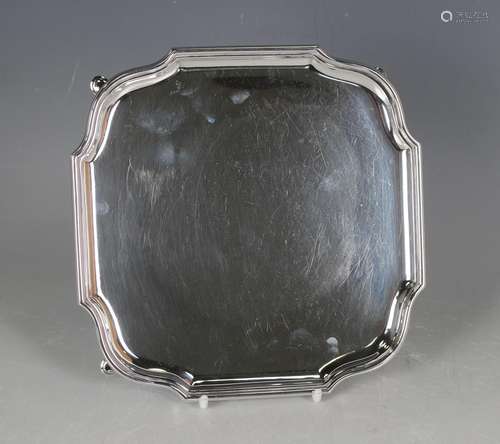 A George V silver square card salver with serpentine shaped ...