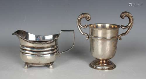 A George III silver cream jug of cushion form on ball feet, ...