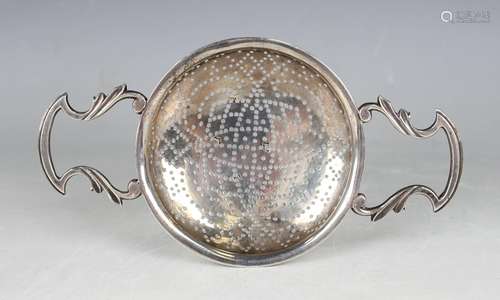 A George II silver lemon strainer, the pierced circular bowl...