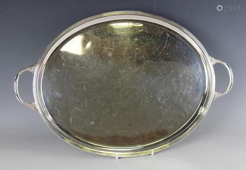 An Elizabeth II silver oval tray with raised rim and foliate...