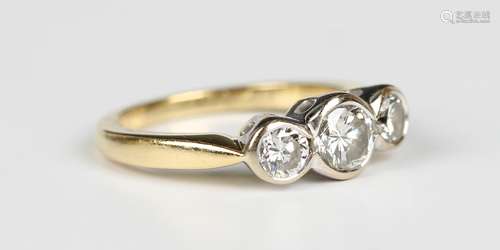 An 18ct gold and diamond three stone ring, collet set with c...