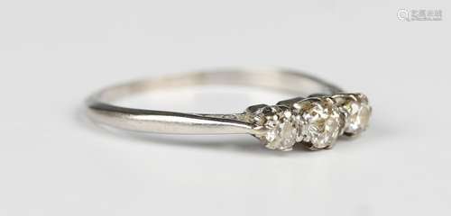 A diamond and colourless gem set three stone ring, claw set ...