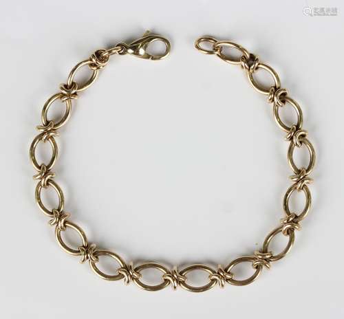 A 9ct gold bracelet in an oval and twist link design, on a s...