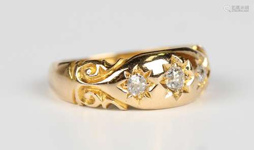 An 18ct gold and diamond three stone ring, star gypsy set wi...