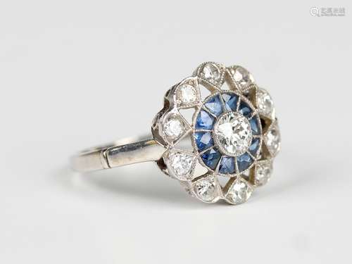 A diamond and sapphire cluster ring of pierced openwork foli...