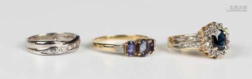 A gold, sapphire and diamond oval cluster ring, claw set wit...