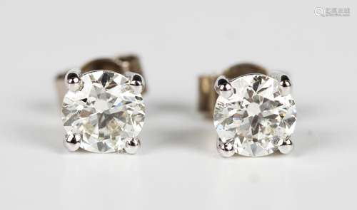 A pair of white gold and diamond single stone earstuds, each...