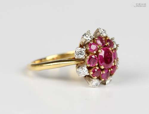 A gold, ruby and diamond cluster ring, claw set with the pri...