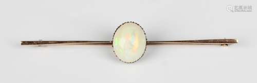 A gold and opal single stone bar brooch, claw set with an ov...