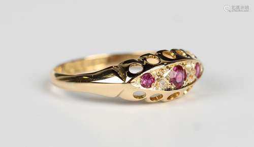 An 18ct gold, ruby and diamond ring, mounted with three cush...