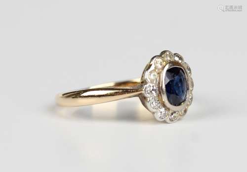 A gold, platinum, sapphire and diamond oval cluster ring, co...