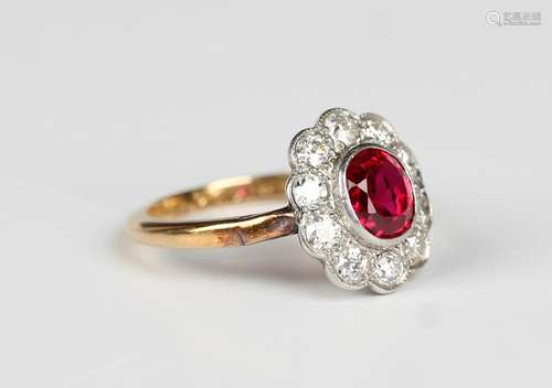 A gold, platinum, ruby and diamond oval cluster ring, collet...