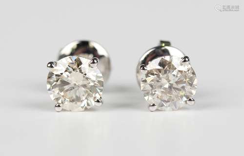 A pair of white gold and diamond single stone earstuds, each...