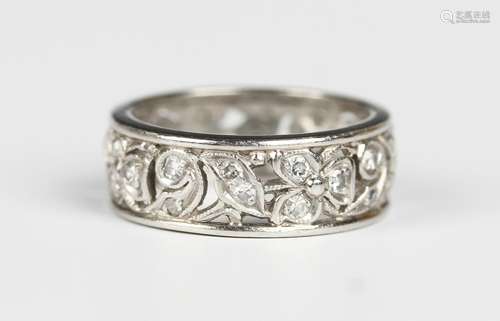 A diamond eternity ring, pierced in a foliate and scrolling ...