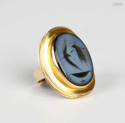 A gold and banded agate oval intaglio ring in the classical ...